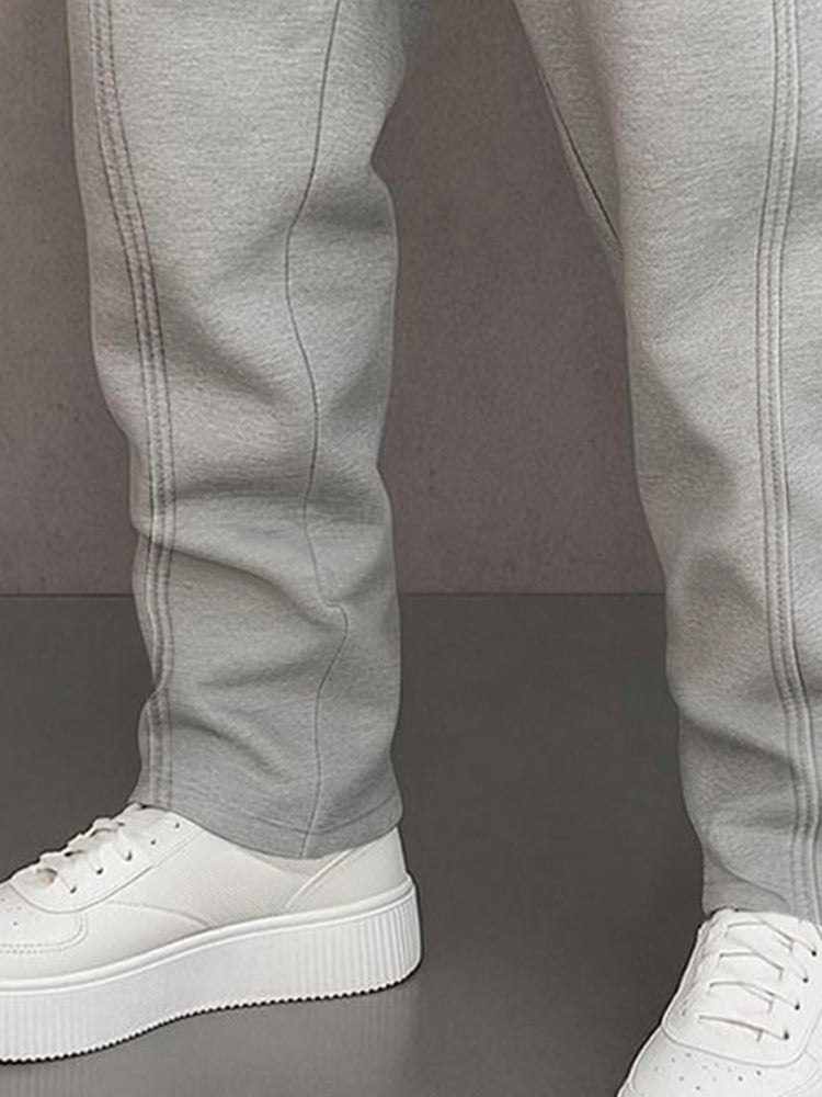 Track pants for men with drawstring waist and button hem detail