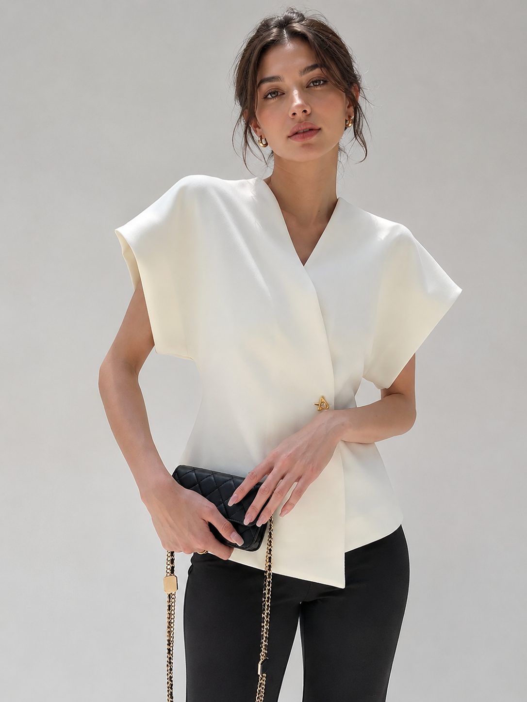 V-neck blouse for women with cap sleeves and single button fastening