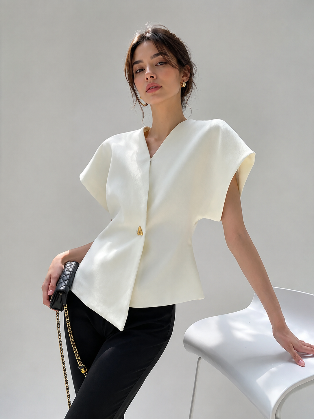 V-neck blouse for women with cap sleeves and single button fastening