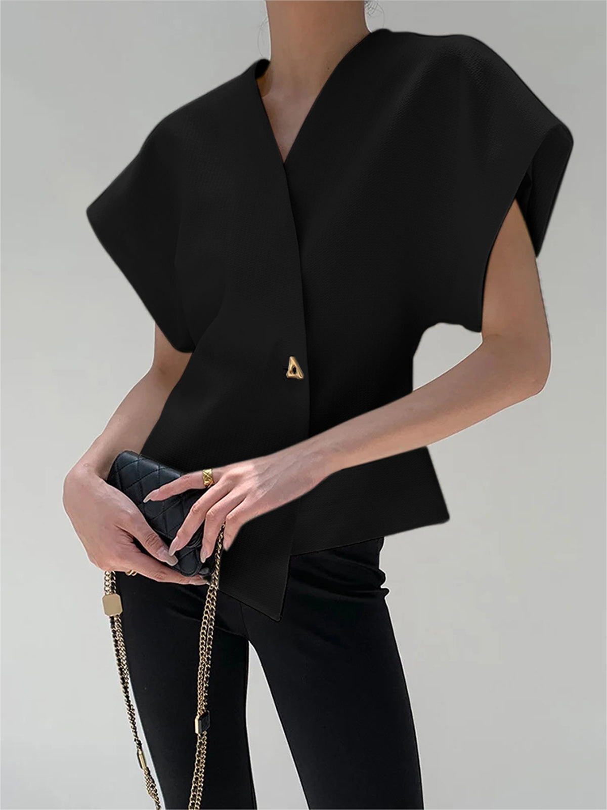 V-neck blouse for women with cap sleeves and single button fastening