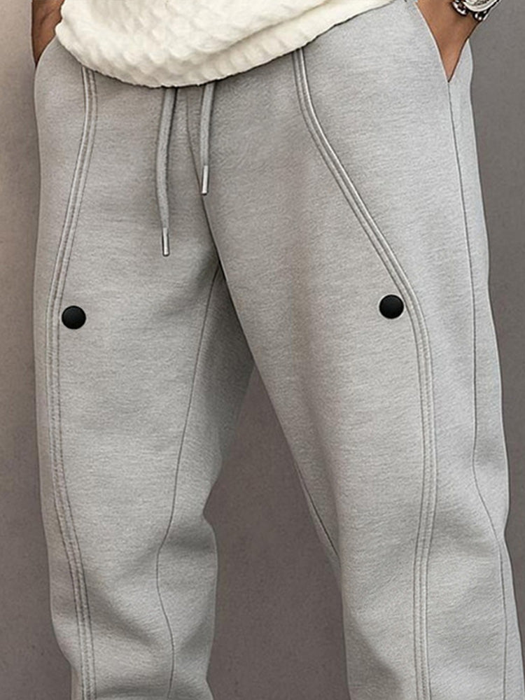 Track pants for men with drawstring waist and button hem detail
