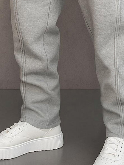 Track pants for men with drawstring waist and button hem detail