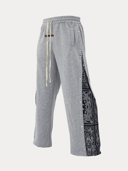 Flared track pants for men with paisley side panel and snap buttons
