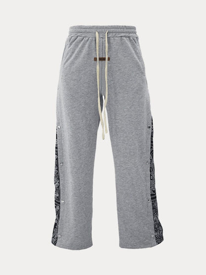 Flared track pants for men with paisley side panel and snap buttons